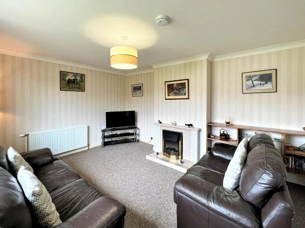 a living room with a couch and a fireplace at Westerdales in Fort Augustus