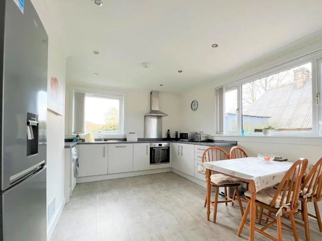 a kitchen with a table and chairs in a kitchen at Westerdales in Fort Augustus
