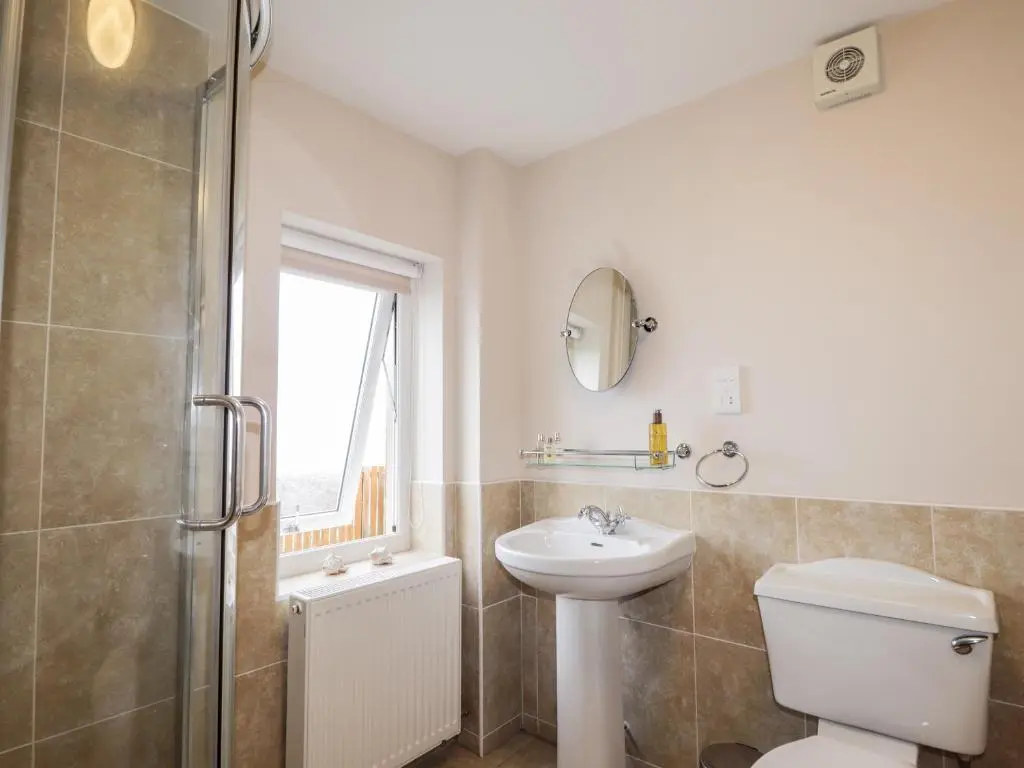 a bathroom with a toilet and a sink and a shower at Learig in Buckie