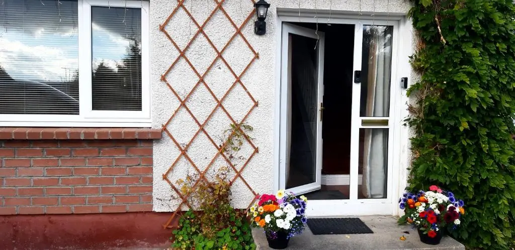 a house with flowers in front of a door at 1 Bed Flat - Sleeps 4 - Garden - Parking - Wifi in Inverness
