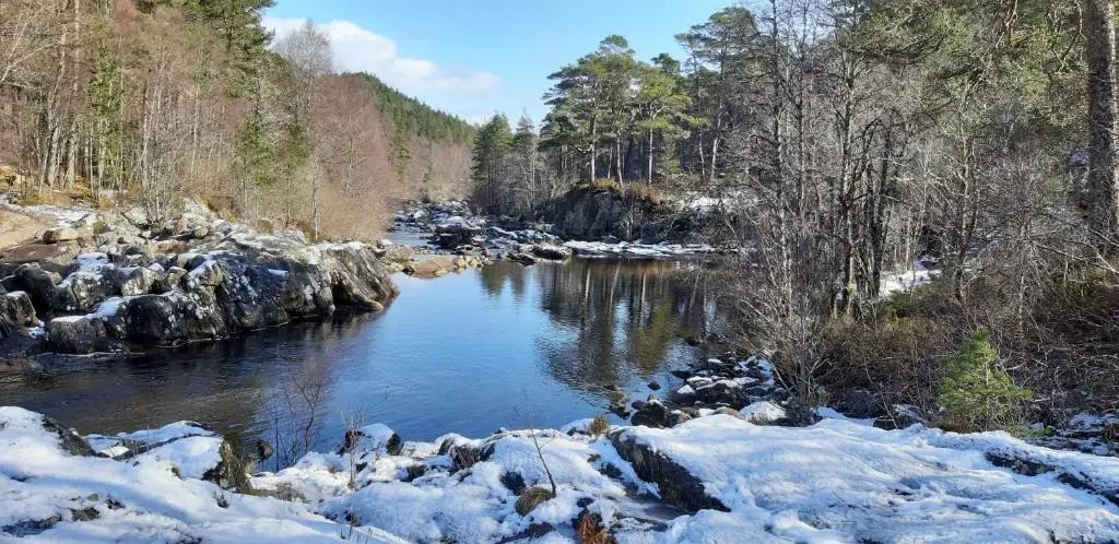 a river covered in snow with rocks and trees at 1 Bed Flat - Sleeps 4 - Garden - Parking - Wifi in Inverness