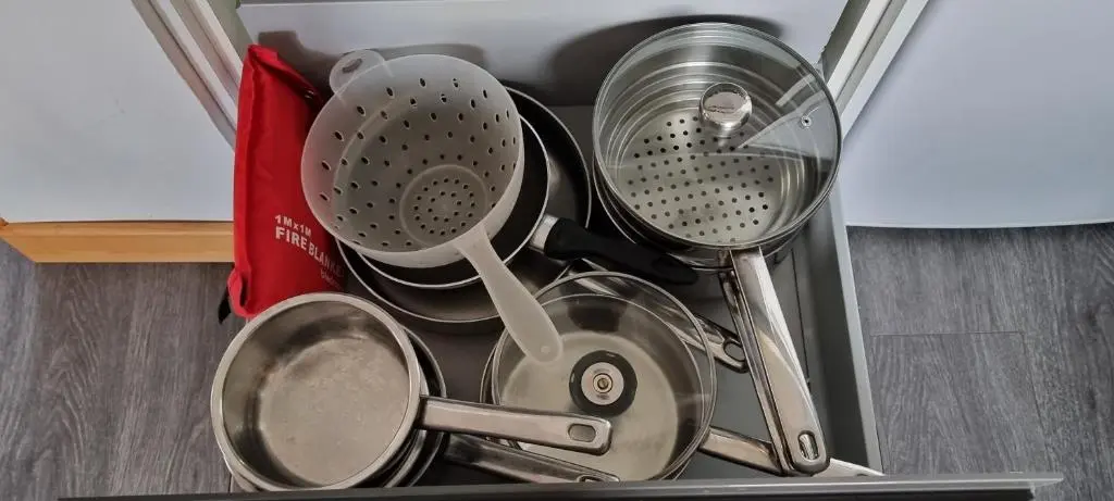 a bunch of kitchen utensils sitting in a drawer at The Shelter Stone Cottage in Aviemore