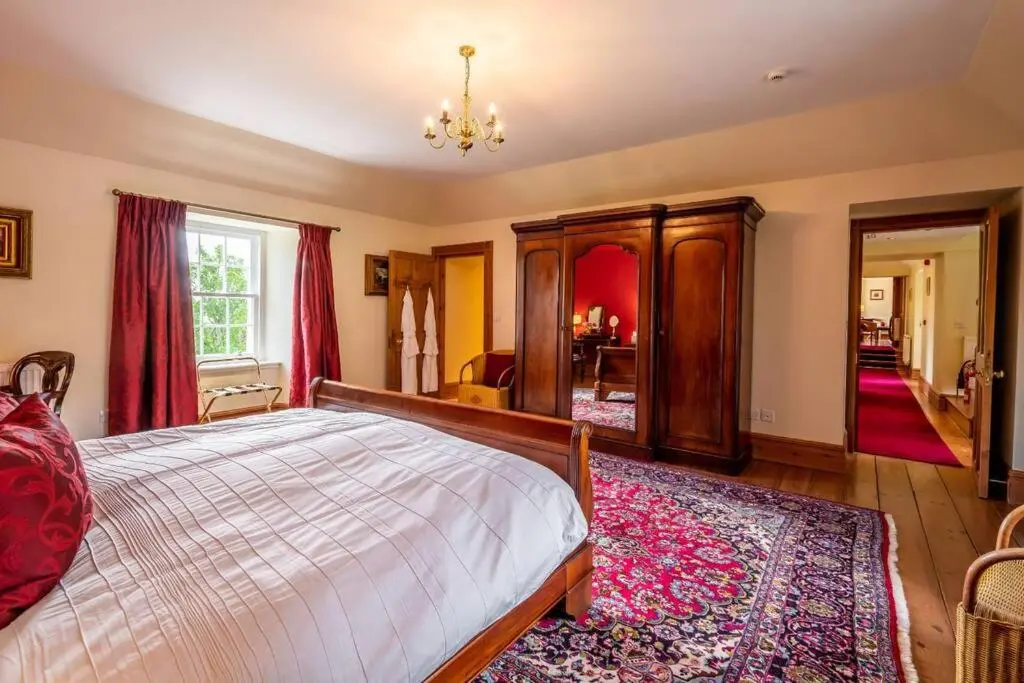 a bedroom with a large bed in a room at Assynt House - Exclusive Use Holiday House in Dingwall