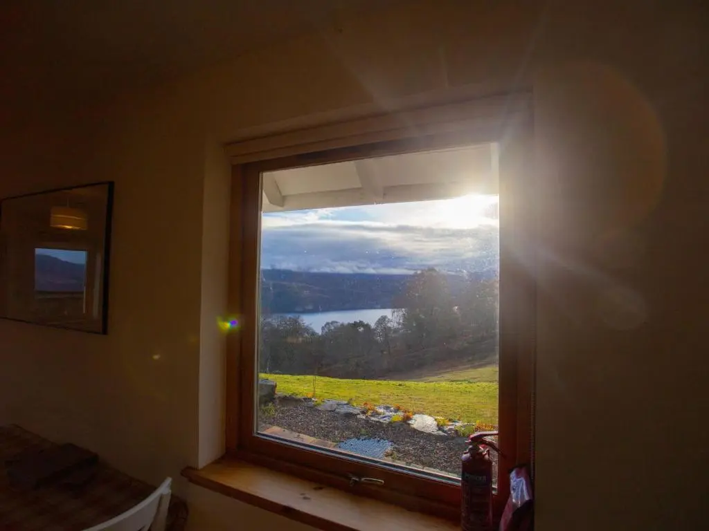 a window in a room with a view of a lake at Holiday Home Peter's Shed by Interhome in Drumnadrochit