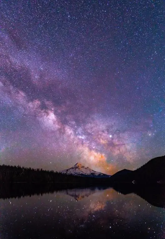 a starry night with the milky way over a mountain at Stag's Hide in Aviemore