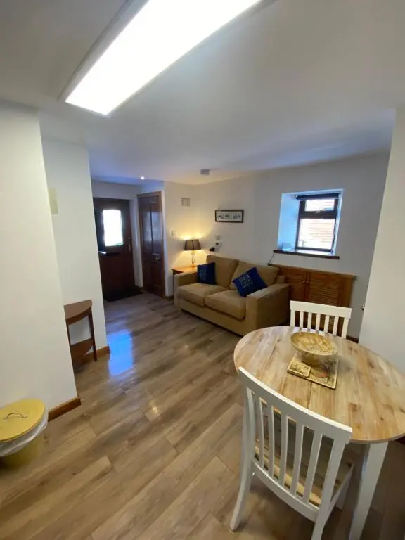 a living room with a table and a couch at Ben View Aberlour Luxury Barn Conversion in Aberlour