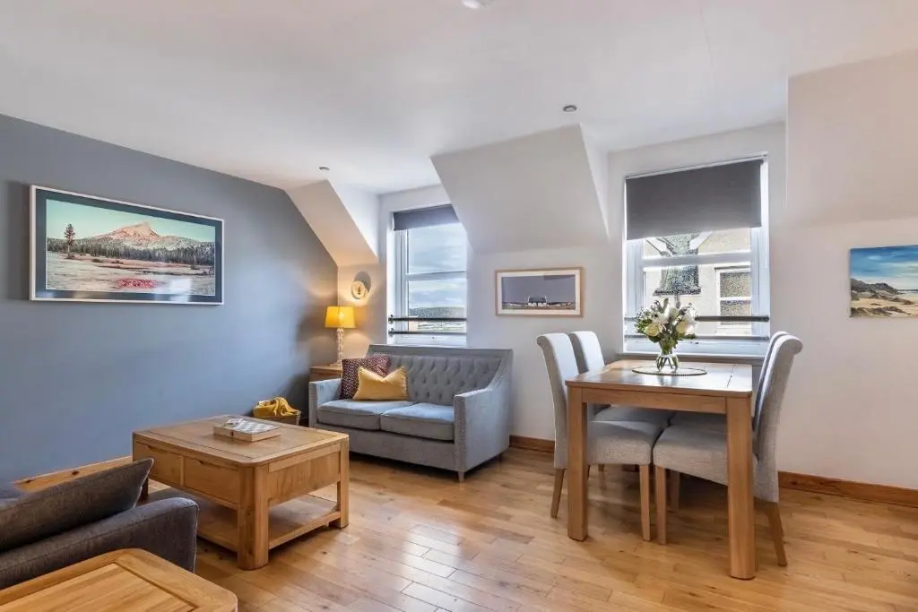 a living room with a couch and a table at The Rooftops Reservation in Inverness