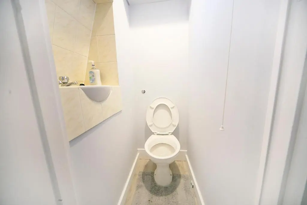 a white bathroom with a toilet and a sink at Constancevilla B9 - Grampian Lettings Ltd in Aberdeen