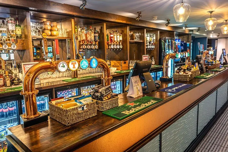 a bar with a counter with wicker baskets on it at Camping Pods Silver Sands Holiday Park in Lossiemouth