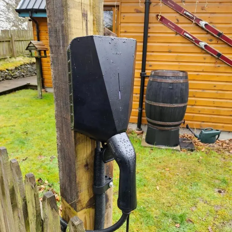 a black mailbox attached to a wooden fence with a barrel at Baltinna East - by Where Stags Roar in Newtonmore