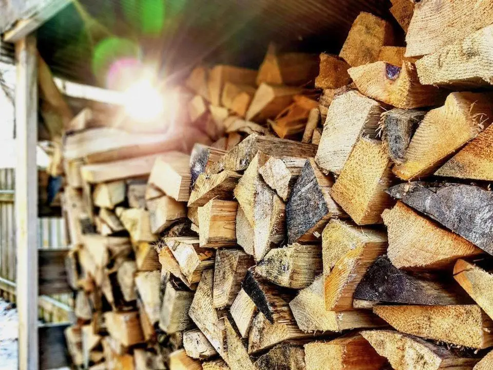 a pile of wood is stacked in a warehouse at Baltinna West - by Where Stags Roar in Newtonmore