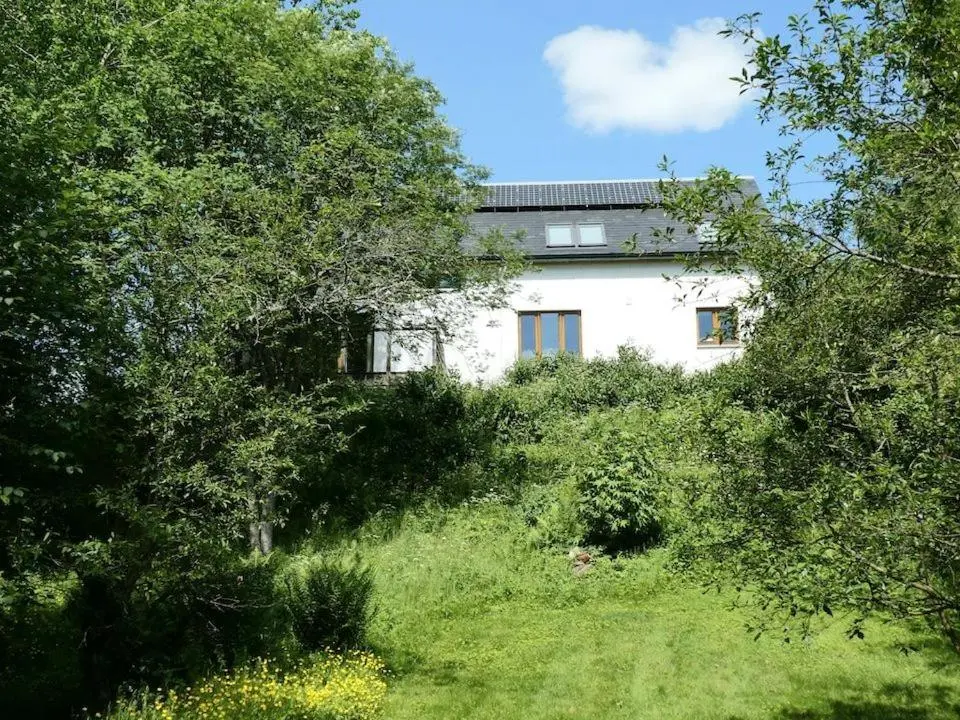a white house in the middle of some trees at The Byre - by Where Stags Roar in Newtonmore