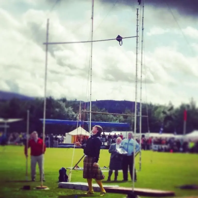 a man is flying a kite in a field at The Bakehouse - by Where Stags Roar in Newtonmore