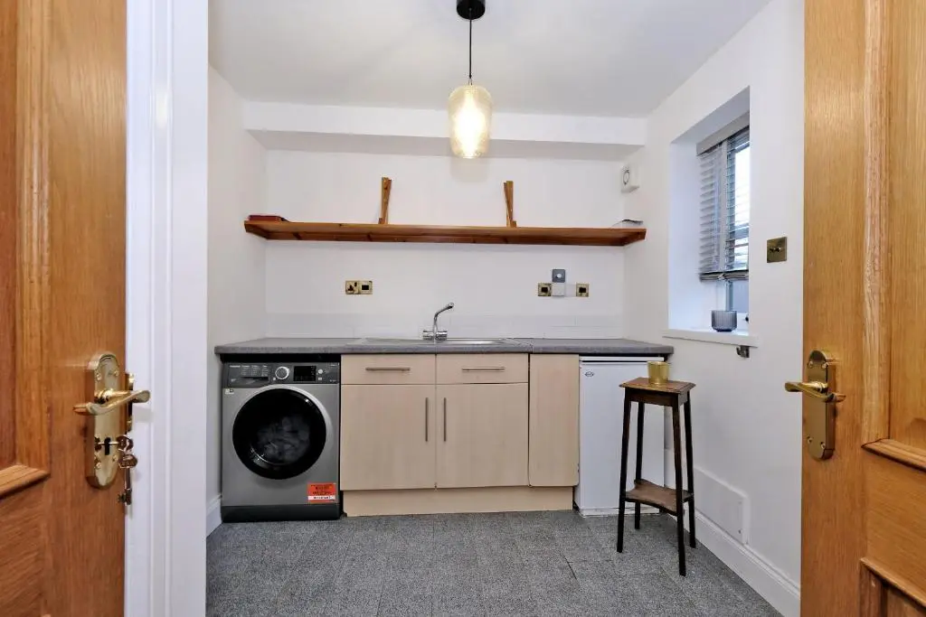 a kitchen with a sink and a washing machine at Rosebrae in Insch