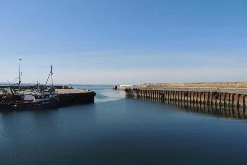 a boat is docked at a dock in the water at Telford Escape in Elgin