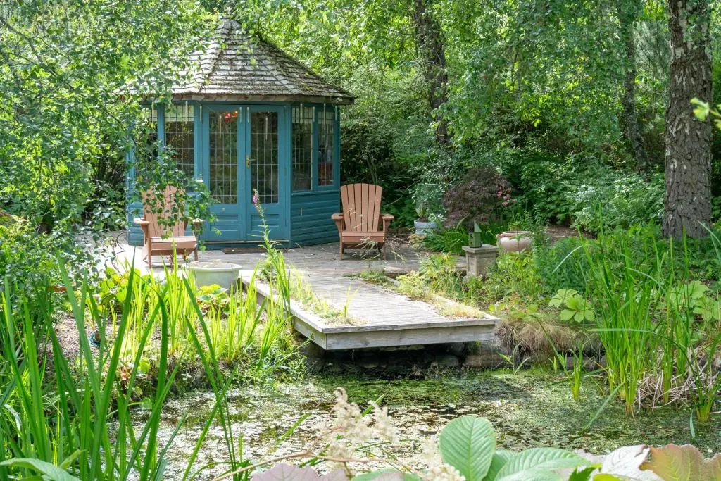 a gazebo in the middle of a garden at The Polchar - Aviemore in Aviemore