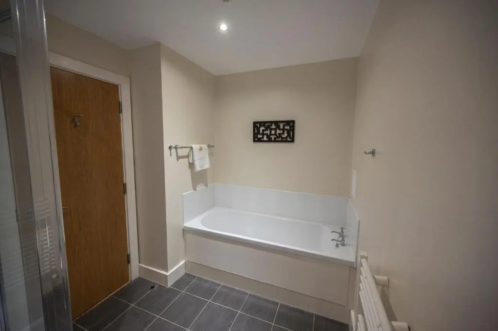 a bathroom with a bath tub in a room at Cloister View in Fort Augustus