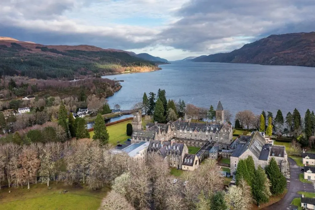 an aerial view of a castle next to a body of water at Cloister View in Fort Augustus