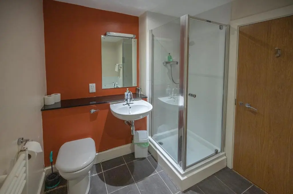 a bathroom with a shower and a sink and a toilet at Cloister View in Fort Augustus