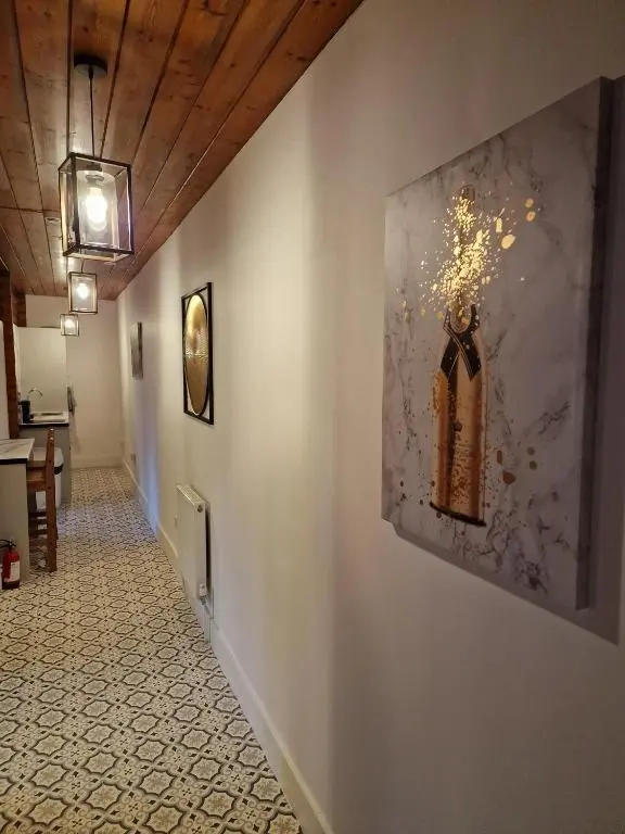 a hallway with a painting on the wall at Kaoglen Warren - Pet friendly - Hot Tub - Cairngorms in Blairgowrie