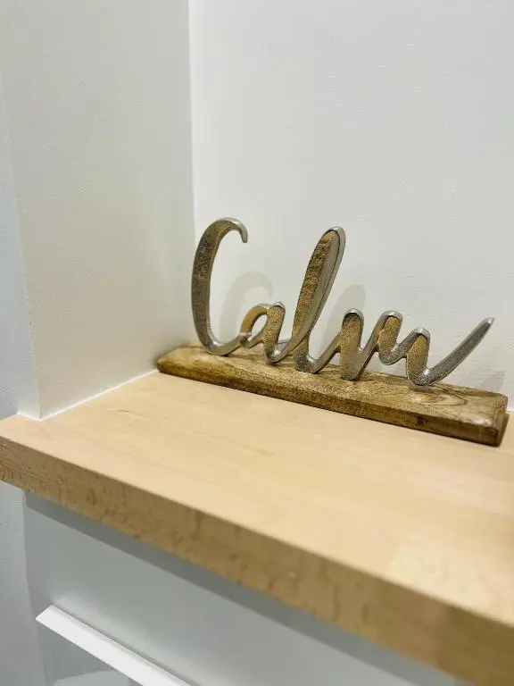 a shelf with metal letters on top of it at St Duthus Villa Guesthouse in Tain