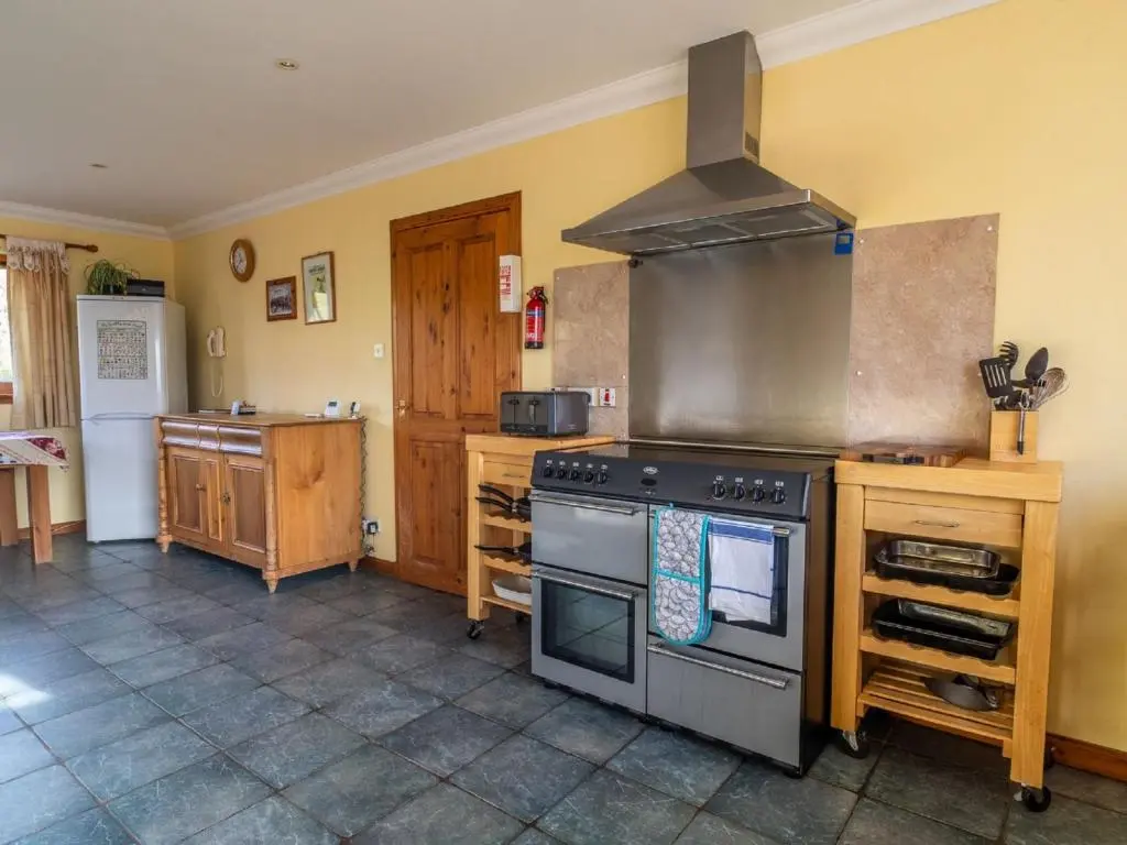 a kitchen with a stove and a counter in it at Holiday Home Ceilidhtail Cottage by Interhome in Drumnadrochit