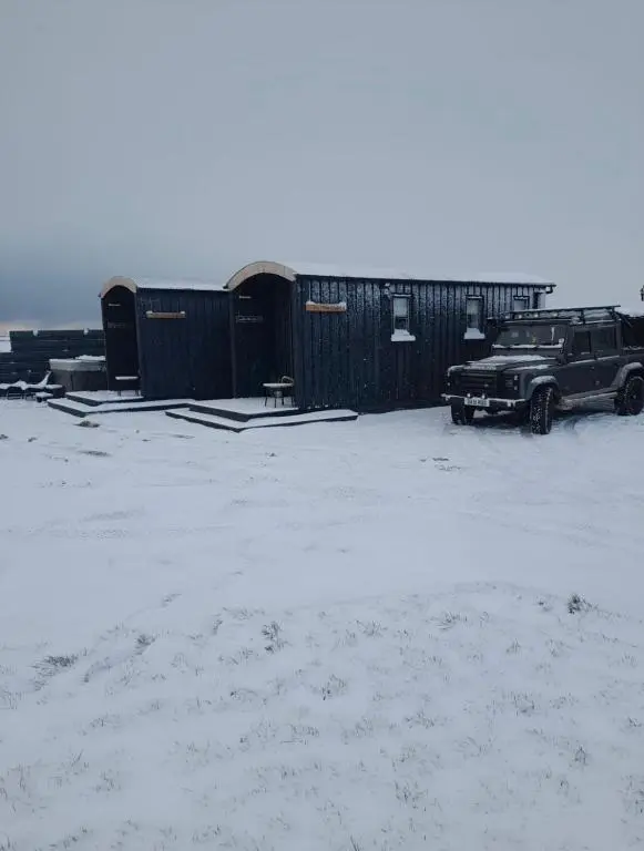 a parking lot with a jeep parked next to a building at Hot Tub Haven Farr North 2 in Wick