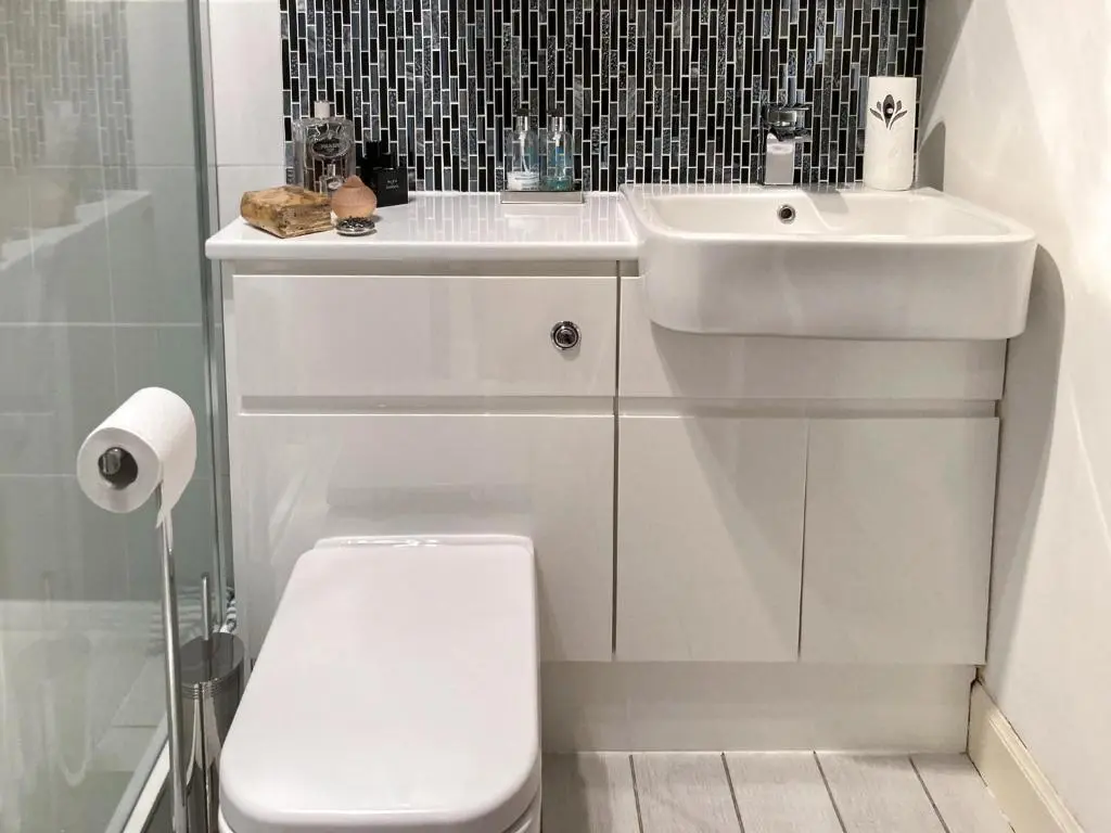 a white bathroom with a toilet and a sink at Dee Valley View in Aboyne