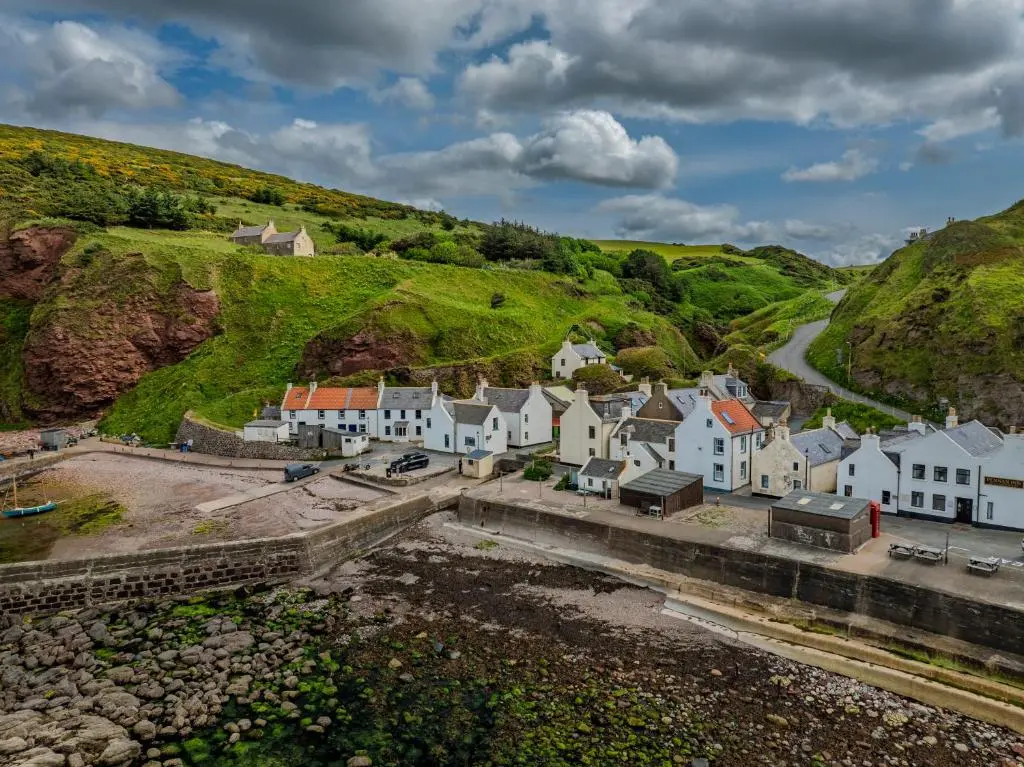 an aerial view of a village with houses and a road at Fisherman's Cottage in Pennan in Pennan