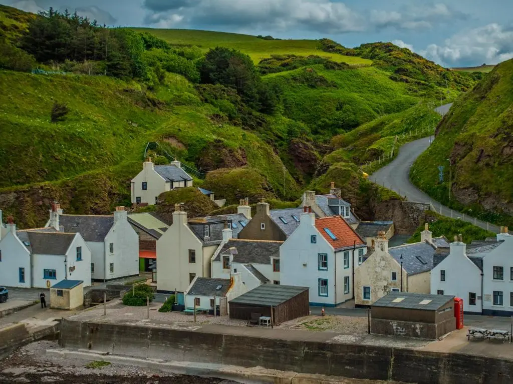 a village with houses and a winding road at Fisherman's Cottage in Pennan in Pennan