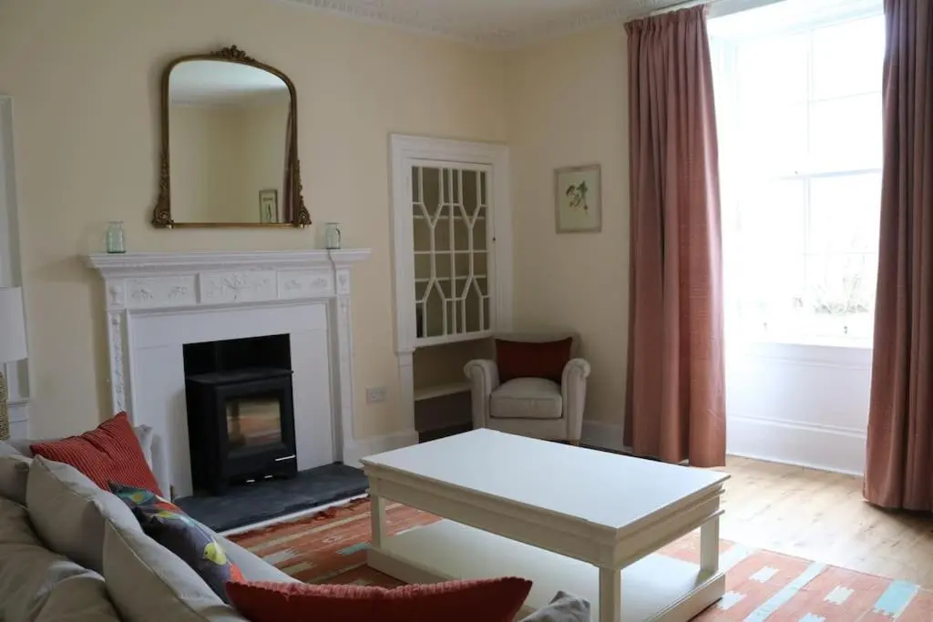 a living room with a couch and a fireplace at Oldwood. Fyvie. in Turriff