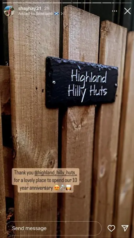 a sign that says highland hilly hits on a wooden fence at Highland cabin - relaxing hot tub in Inverness