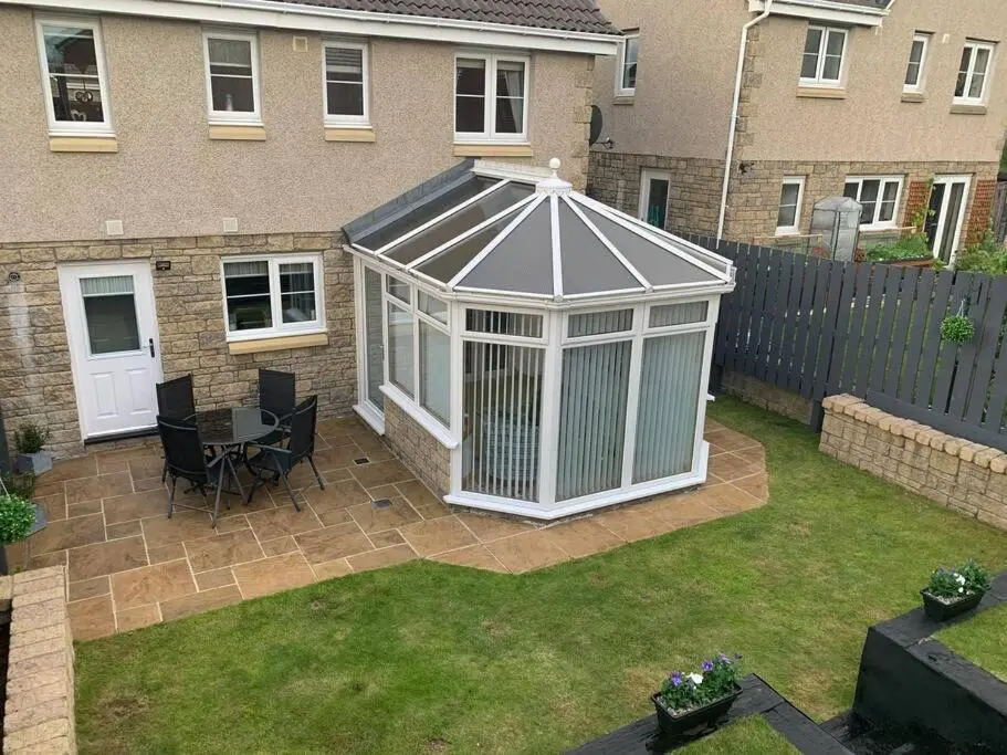 a white gazebo in the backyard of a house at Three bedroom house in Culloden, Inverness in Culloden