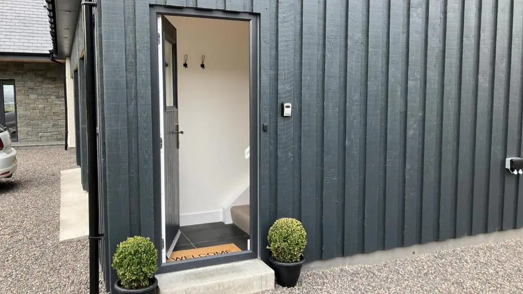 a bathroom mirror on the side of a building at Berryfield Holiday Apartment in Inverness