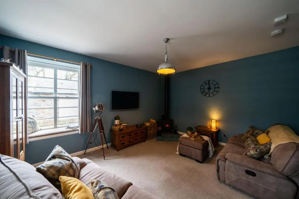 a living room with a couch and a tv at Ranch House Cottage, Pet Friendly Stay, Inverurie in Thainstone