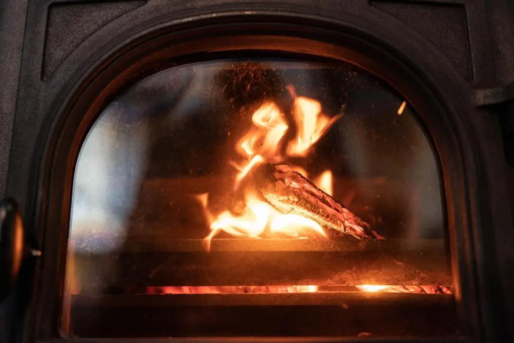 a fireplace with a piece of food cooking in it at Ranch House Cottage, Pet Friendly Stay, Inverurie in Thainstone