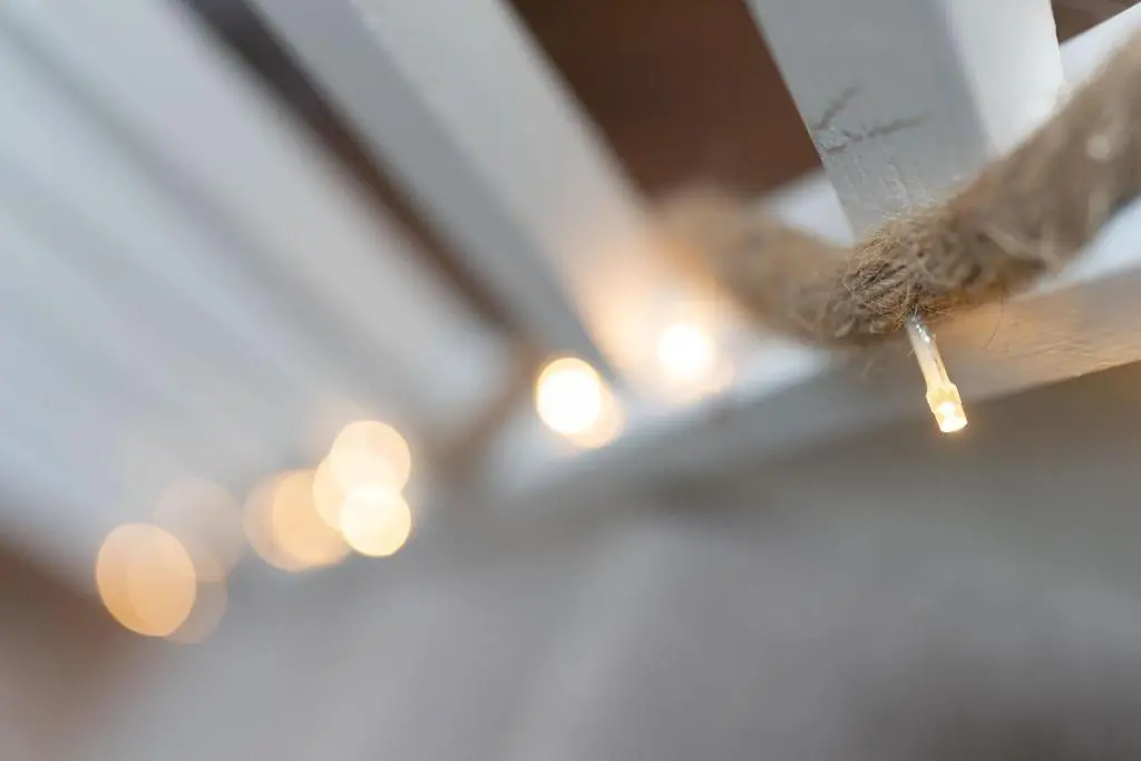 a piece of wood with a piece of rope hanging from a ceiling with lights at Ranch House Cottage, Pet Friendly Stay, Inverurie in Thainstone
