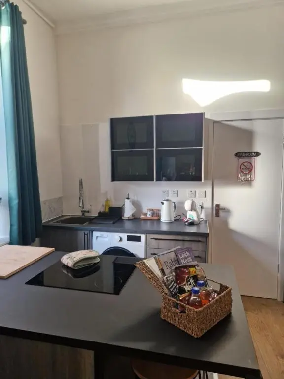 a kitchen with a table and a counter top at Baile Apartment Central Inverness in Inverness