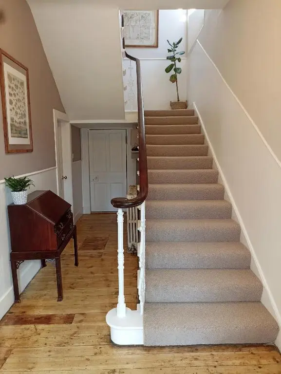 a staircase in a home with a piano at Abbeyfield B&B in Dufftown