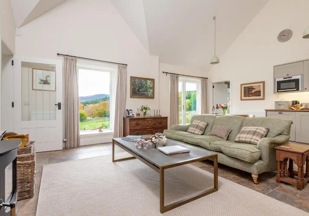 a living room with a couch and a coffee table at The Kennels in Ballogie