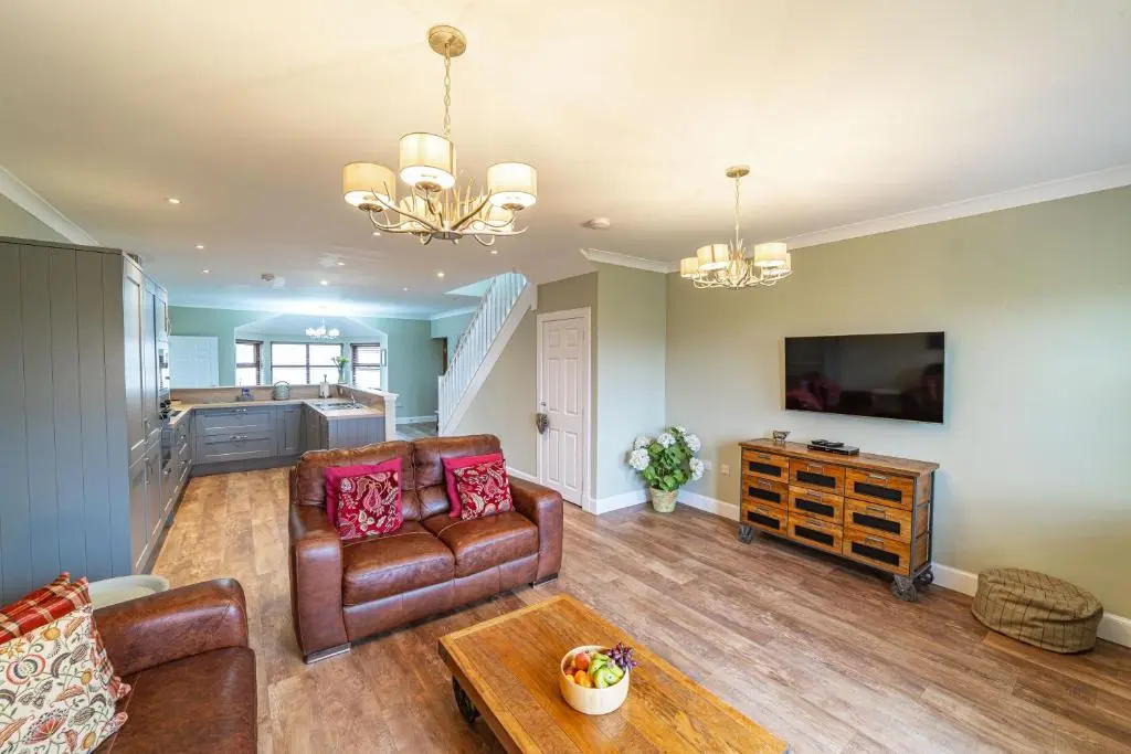 a living room with a couch and a table at Mill House with Hot Tub in Cray