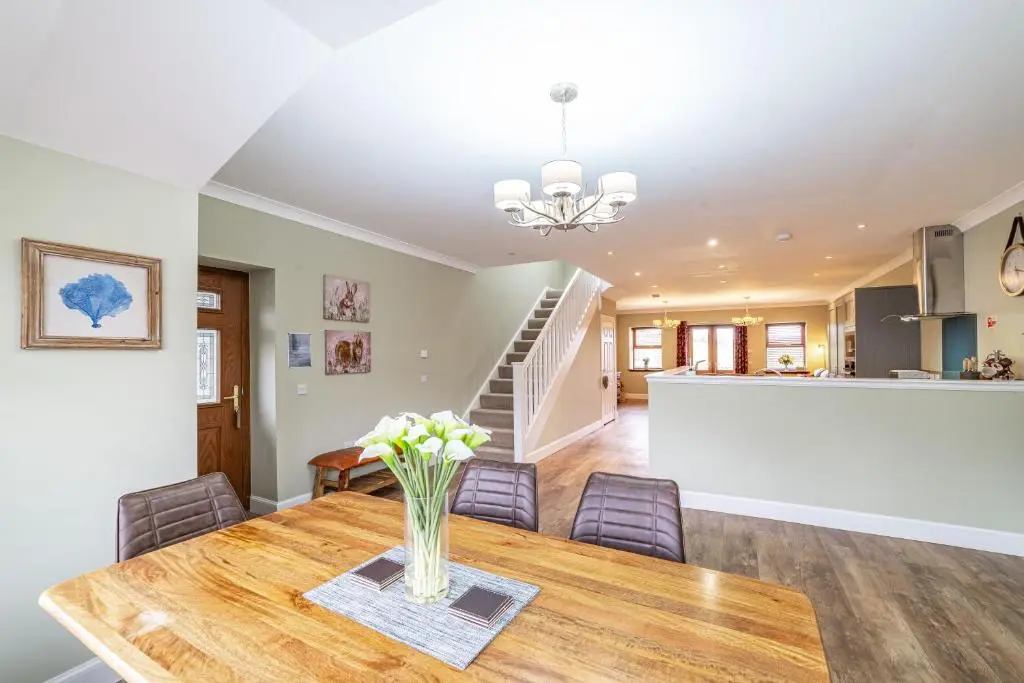 a dining room and living room with a table and chairs at Mill House with Hot Tub in Cray