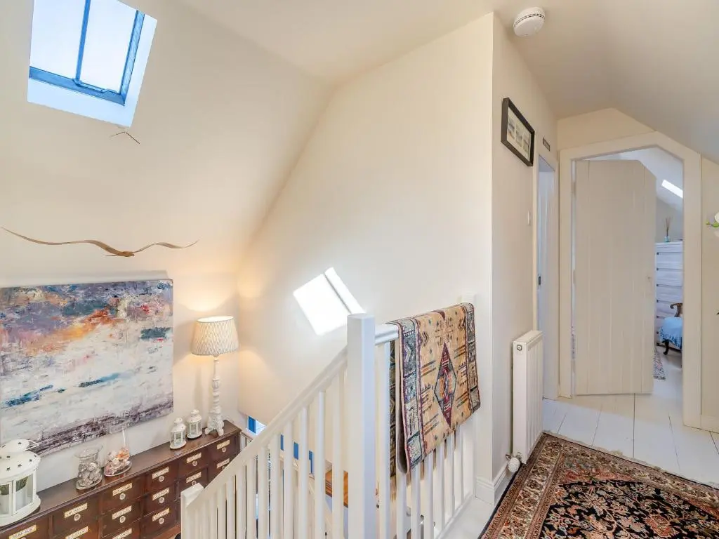 a staircase in a home with white walls and ceilings at The Old Net Shed in Whitehills