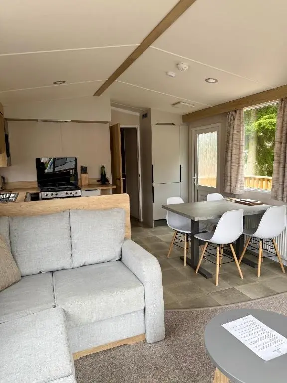 a living room with a couch and a table at The Telford Van - Beautiful, luxury static caravan in Aberlour