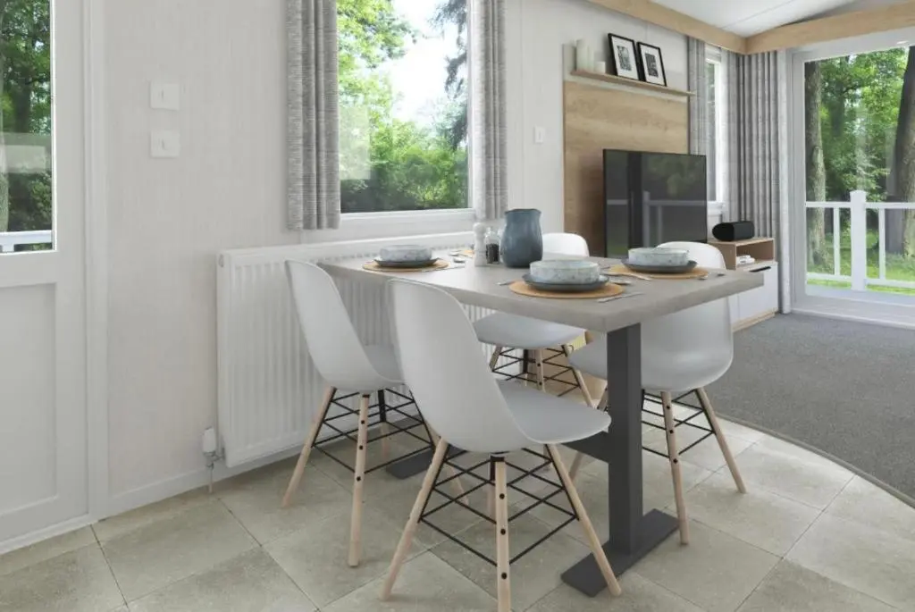 a dining room with a table and white chairs at The Spey Van - Beautiful, luxury static caravan in Aberlour