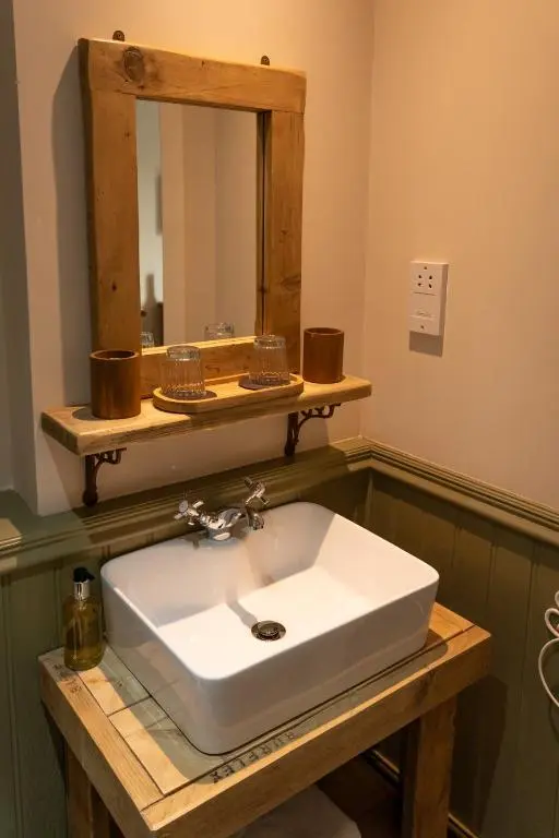 a bathroom with a white sink and a mirror at Bridgend House B&B in Drumnadrochit