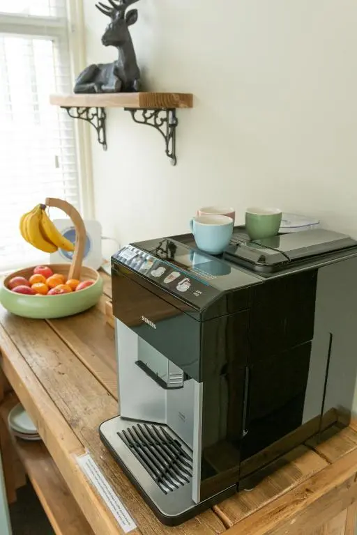 a microwave sitting on top of a wooden table at Bridgend House B&B in Drumnadrochit