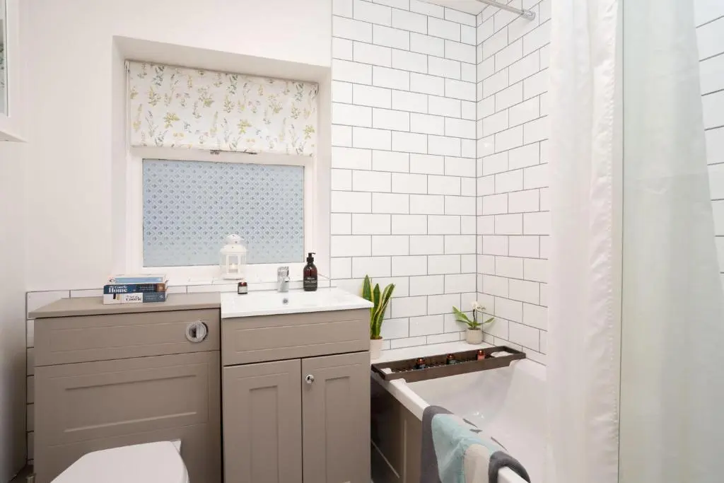 a bathroom with a sink and a toilet and a window at West Lodge - Seasgair Lodges in Kincraig