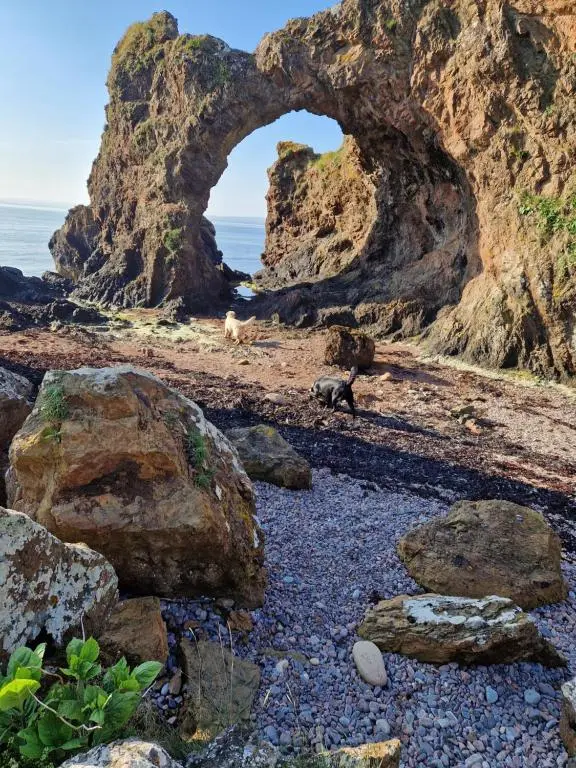 an arch in the rocks on a rocky beach at Room at the Back, 2 George Street in Avoch