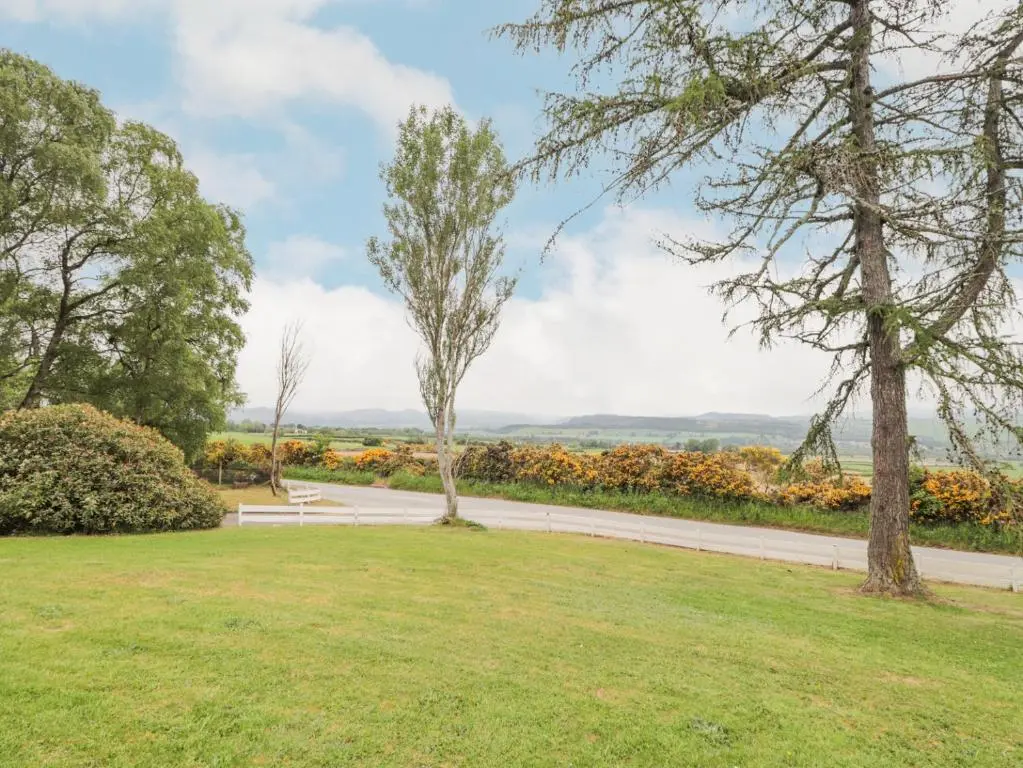 a path through a park with trees and grass at Fresh Fields in Dingwall